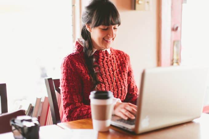 A woman sitting at a table using a laptop