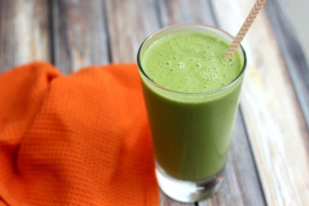 A close up of a glass of smoothie on a table