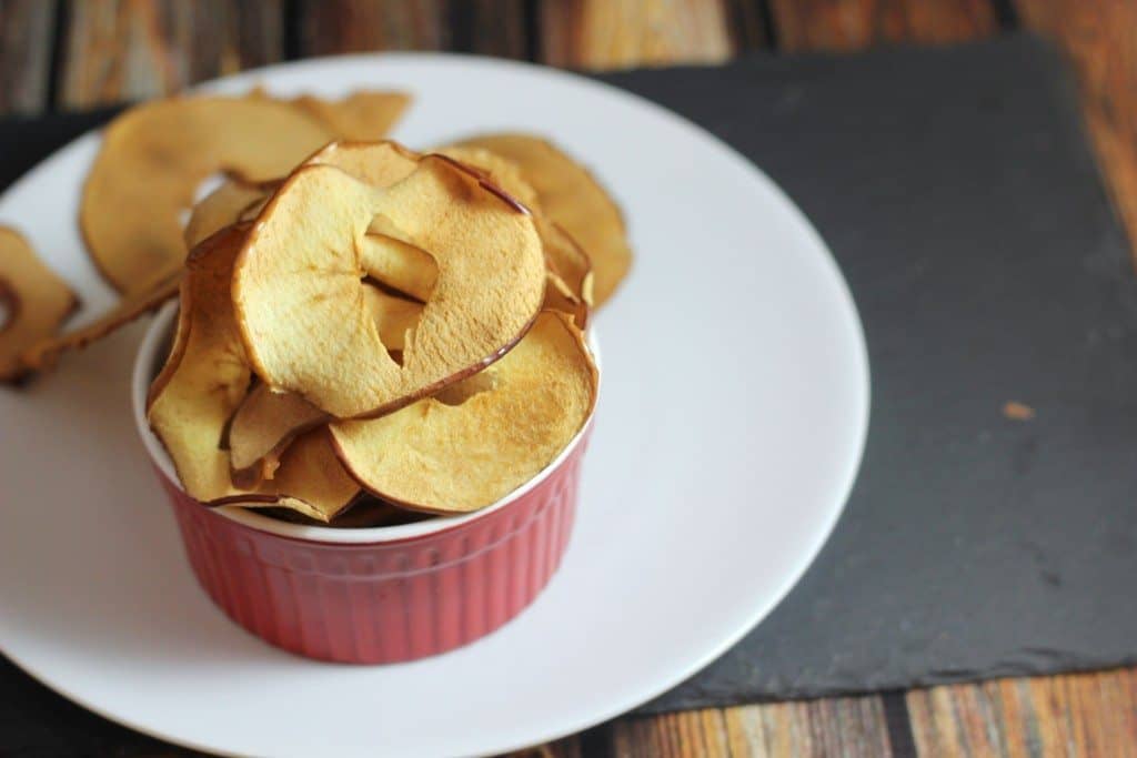 This healthy baked apple chip recipe is almost too easy! You can make these in the oven and have a sweet & crunchy snack!