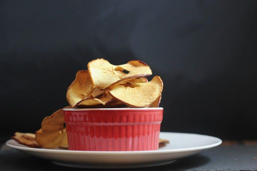 This healthy baked apple chip recipe is almost too easy! You can make these in the oven and have a sweet & crunchy snack!
