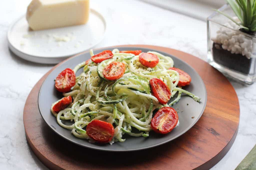 zucchini noodles and tomatoes on a plate