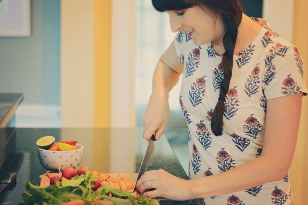 A woman cutting veggies