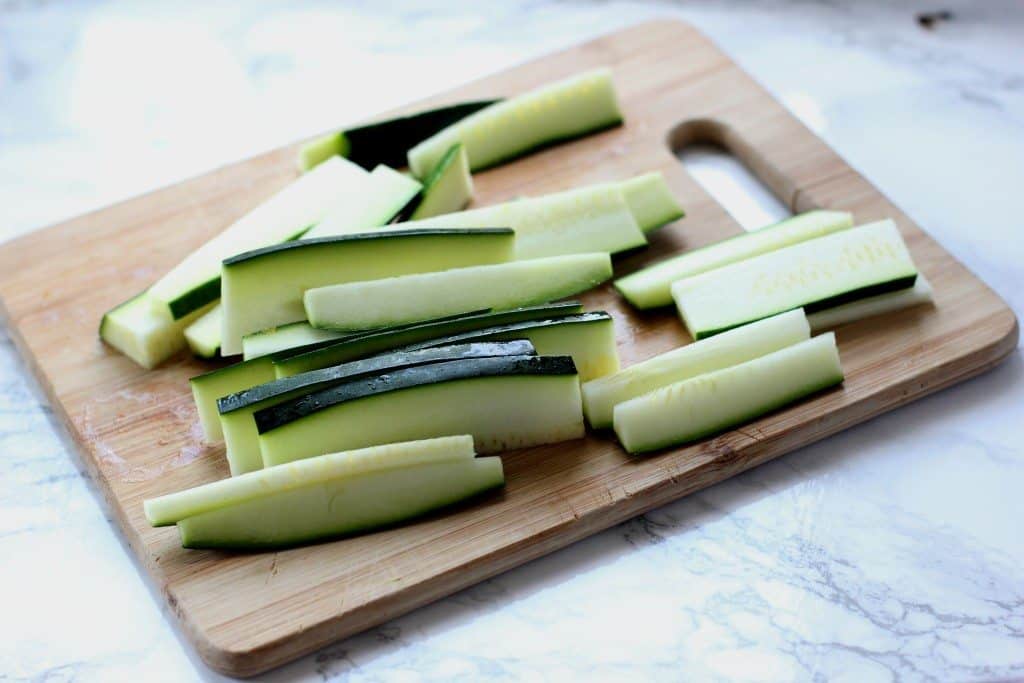 A zucchini on a cutting board