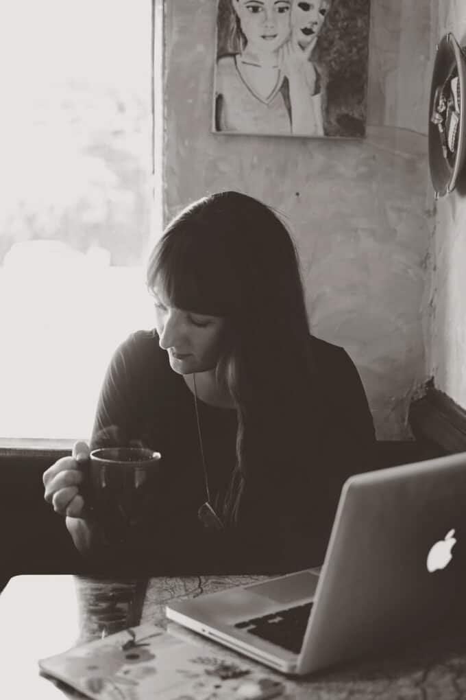 A person sitting at a table in front of a laptop