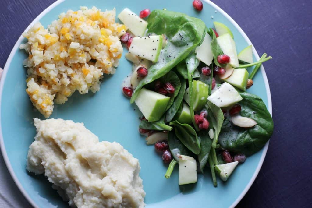 plate of mashed potatoes and spinach salad