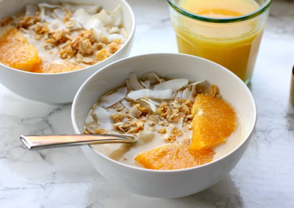 orange smoothie in a bowl with orange juice