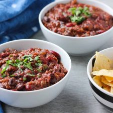 vegan chili in a bowl with chips