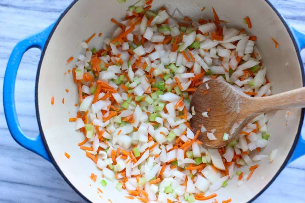 onions, carrots, and celery in a pot