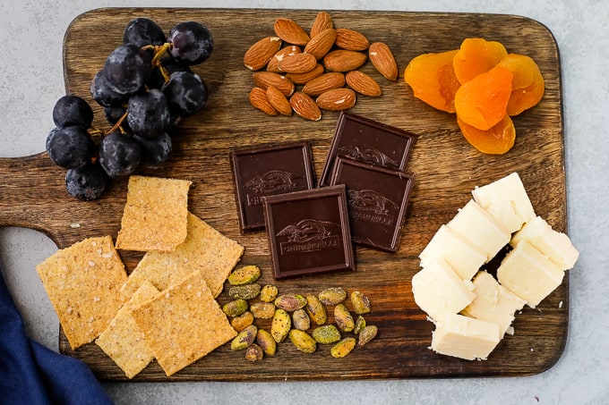 A bunch of food sitting on top of a wooden cutting board