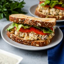 A plate of food on a table, with a  Sandwich