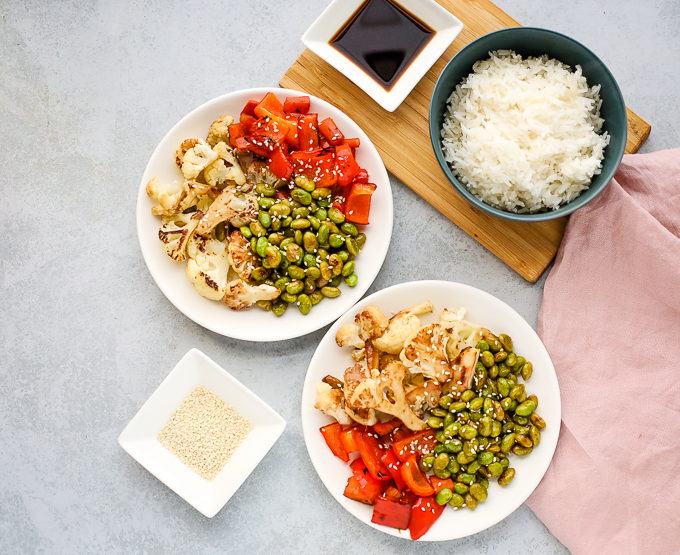 A bowl of rice with different types of food on a plate