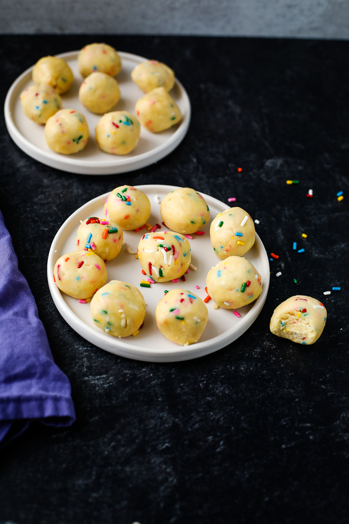 cake batter truffles on a plate with sprinkles