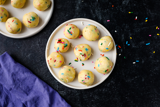 cake batter truffles on a plate with sprinkles