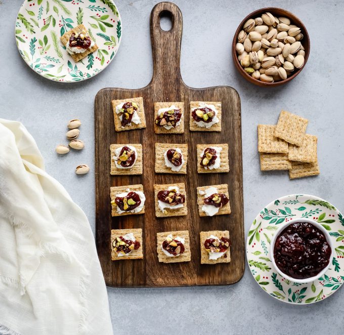 Crackers on a cutting board with toppings