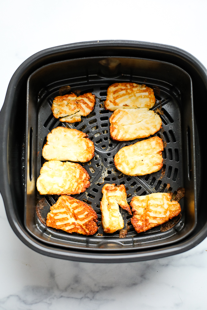 air fryer basket with halloumi cheese