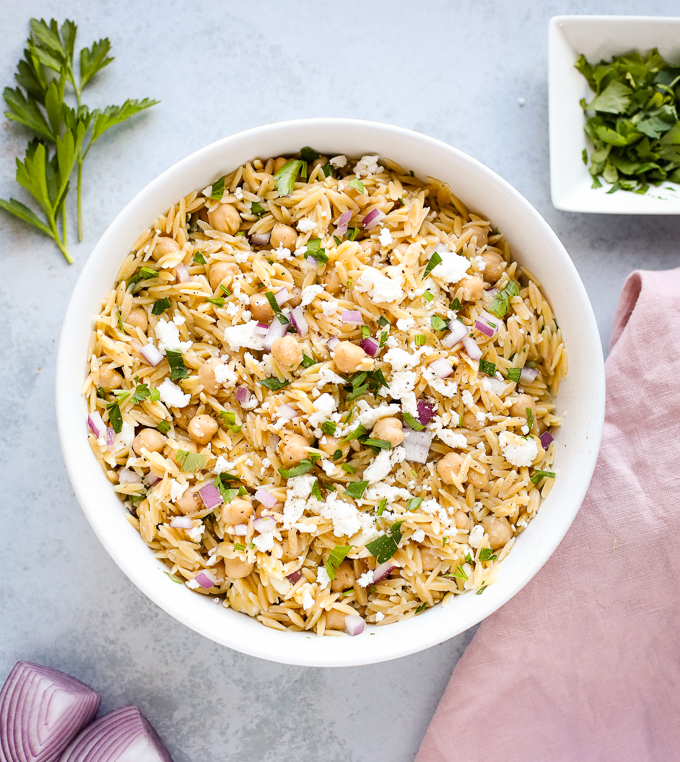 orzo pasta salad in a large white bowl