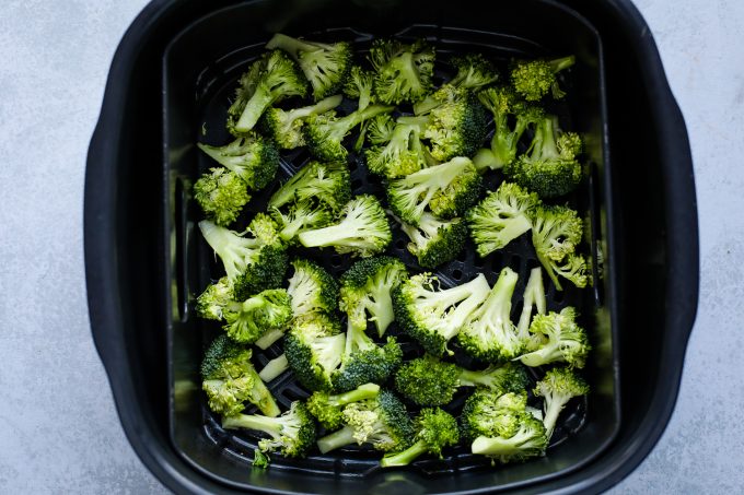 broccoli in an air fryer basket