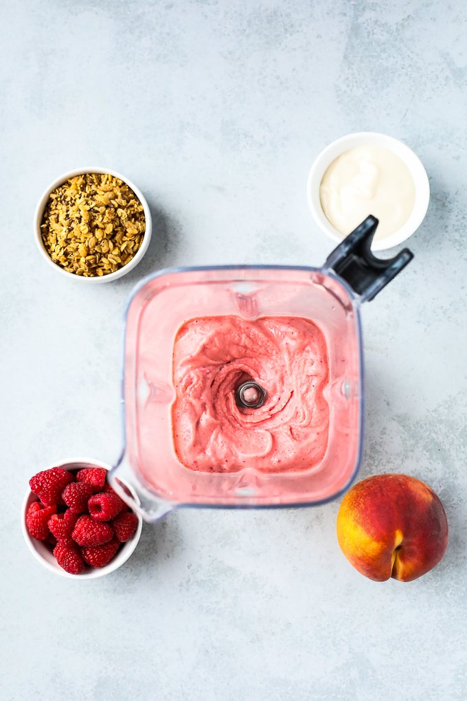 peach raspberry smoothie in a blender