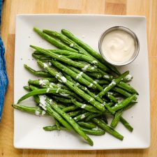 green beans on a plate with aioli