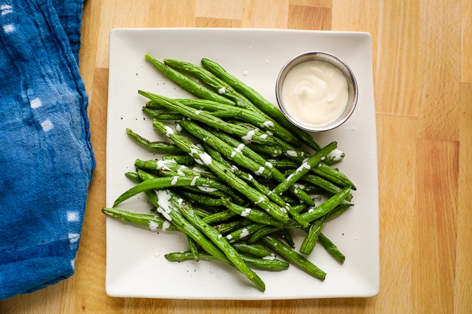 green beans on a plate with aioli