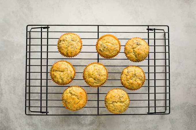 lemon poppy seed muffins on a cooling rack