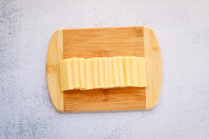 cheddar slices on a cutting board