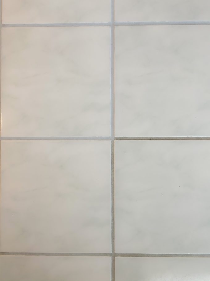 A close up of a tile floor with painted grout