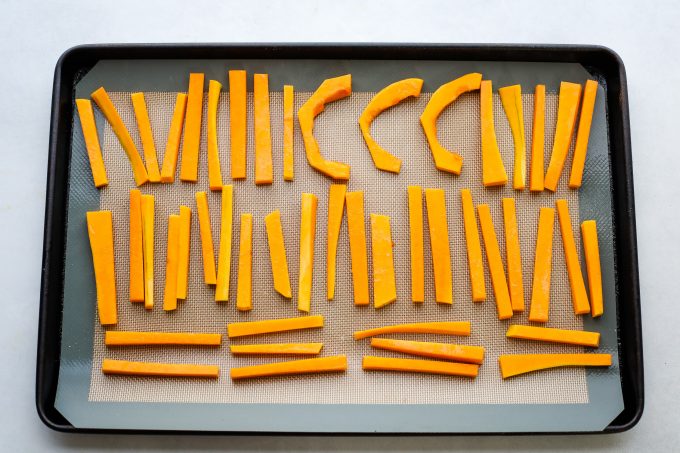 butternut squash slices on a baking sheet