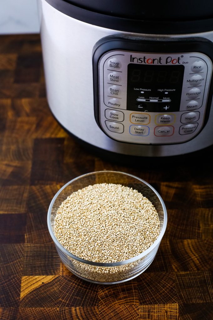 quinoa in a bowl in front of an instant pot