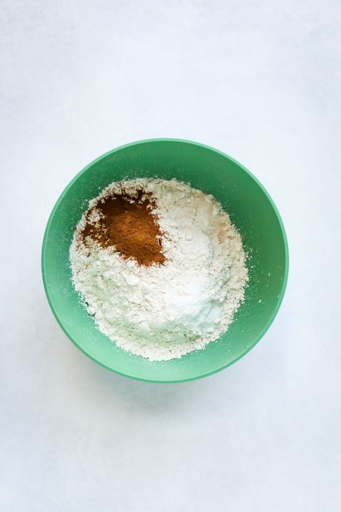 Flour, cinnamon, baking soda, and baking powder in a bowl