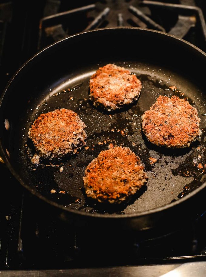 A close up of a pan on a stove with Bean Fritters