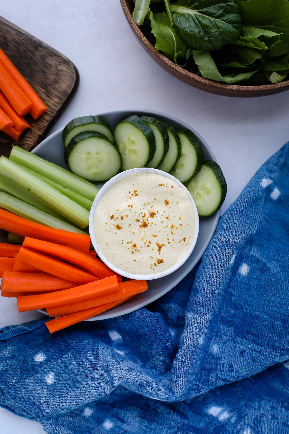 A variety of vegetables on a plate with dip