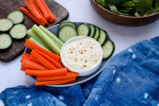 A variety of vegetables on a plate with dip