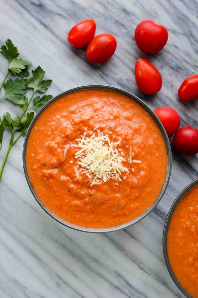 tomato soup in a bowl topped with parmesan