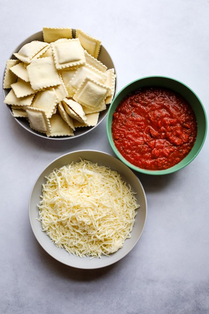 ravioli, mozzarella, and pasta sauce on a table