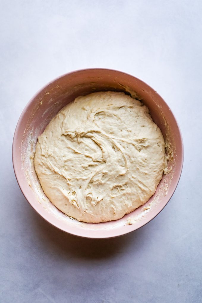 naan dough in a bowl, water, yeast and oil