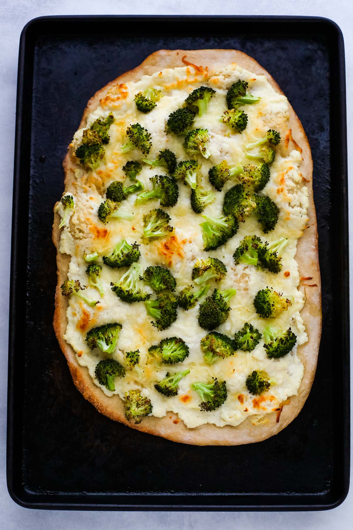 broccoli pizza on a pan