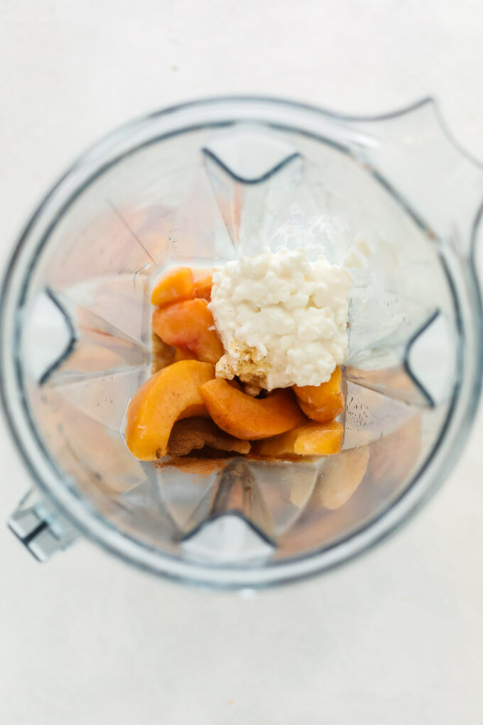 peach mango smoothie ingredients in a blender